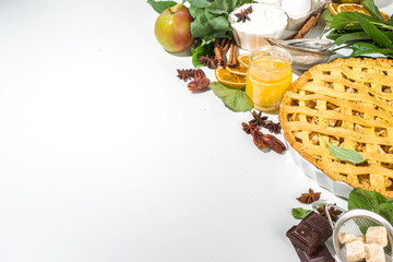 Autumn cooking baking background with sweet apple pie. Traditional american apple pie with fresh apples, cinnamon, spices, baking ingredients, top view copy space on white background