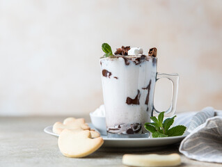 Holiday hot chocolate or cocoa with marshmallow and cinnamon served with homemade butter cookies.