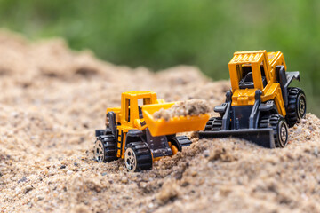 Re-enacting a building lot with toys in a sandbox