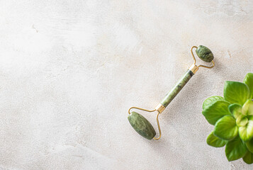 Jade roller for face massage. Facial massage Chinese medicine. Facial massage and beauty concept.