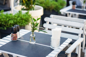 Street Cafe. Close up of empty table and chairs, outdoor terrace, veranda, real scene, seasonal mood concept