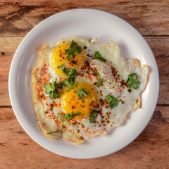 Indian style tasty and healthy double egg half fried omelet on a wooden rustic background. selective focus