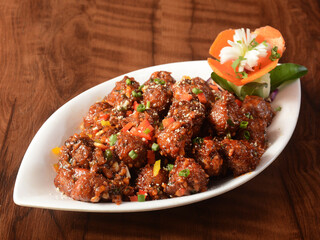 Veg Manchurian, Popular indo-chinese food made of cauliflower florets and other vegetable, served...