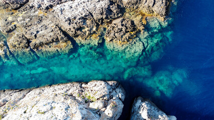 Aerial view of a narrow passage of turquoise waters between two small islands in the Mediterranean Sea, east of Ibiza, Spain