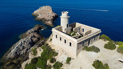 Aerial view of the abandonned lighthouse on the Punta Grossa cape, in the east of Ibiza island in the Balearic Islands, Spain - Ruins of a square based lighthouse with a round tower