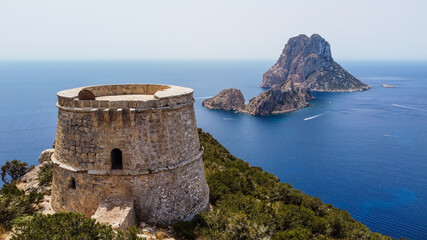 Aerial view of the Torre des Savinar, at the western tip of Ibiza island in the Balearic Islands, Spain - Medieval fortified tower overlooking the Mediterranean Sea - obrazy, fototapety, plakaty