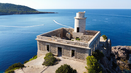 Aerial view of the abandonned lighthouse on the Punta Grossa cape, in the east of Ibiza island in...