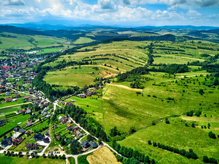 Fototapeta na wymiar Beautiful aerial panoramic view of the Pieniny National Park, Poland in sunny day. Sokolica and Trzy Korony - English: Three Crowns (the summit of the Three Crowns Massif) and Dunajec river