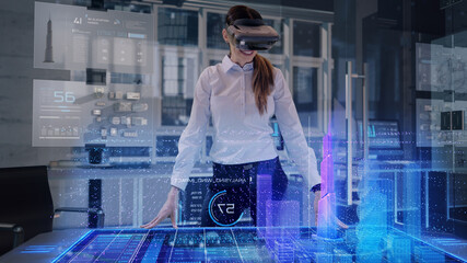 Professional Female Architect wearing Augmented Reality Headset makes gestures and redesigns 3D...