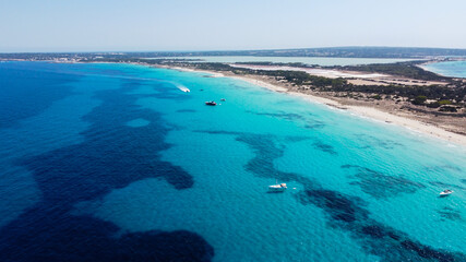 Fototapeta na wymiar Aerial view of the beaches of Ses Illetes on the island of Formentera in the Balearic Islands, Spain - Turquoise waters on both sides of a sand strip in the Mediterranean Sea