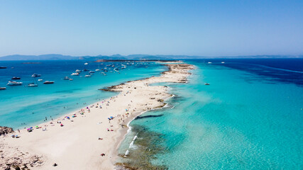 Aerial view of the beaches of Ses Illetes on the island of Formentera in the Balearic Islands, Spain - Turquoise waters on both sides of a sand strip in the Mediterranean Sea - obrazy, fototapety, plakaty