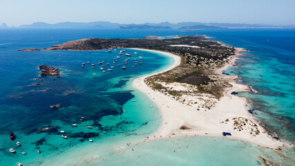 Aerial view of the beaches of Ses Illetes on the island of Formentera in the Balearic Islands, Spain - Turquoise waters on both sides of a sand strip in the Mediterranean Sea