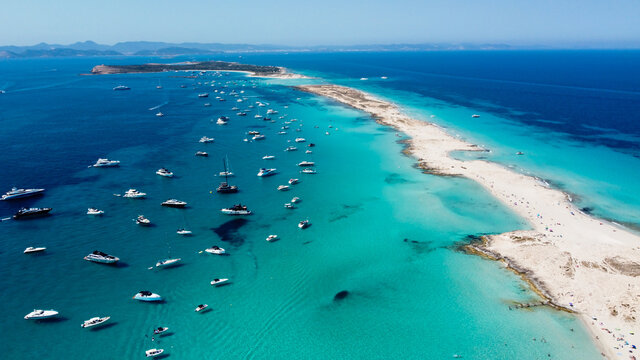Aerial view of the beaches of Ses Illetes on the island of Formentera in the Balearic Islands, Spain - Turquoise waters on both sides of a sand strip in the Mediterranean Sea