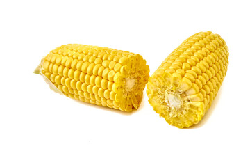 Young appetizing corn on the cob, cut in half and peeled from the leaves on a white background.