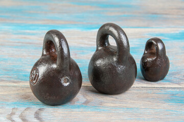 Three antique iron weights for scales.