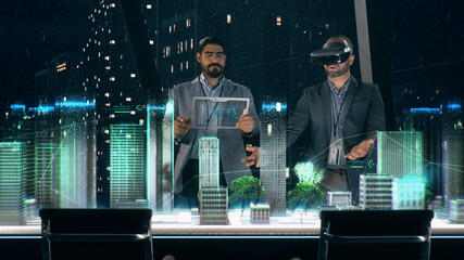 Professional Designer in Suit wearing AR Headset presenting Architecture Project to Partner standing around Futuristic Table with Holographic Modern Augmented Reality Technology.