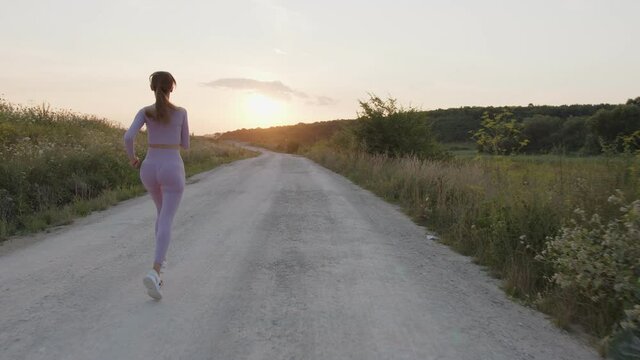 View of a girl that running on a road