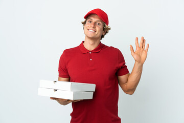 pizza delivery man over isolated white background saluting with hand with happy expression