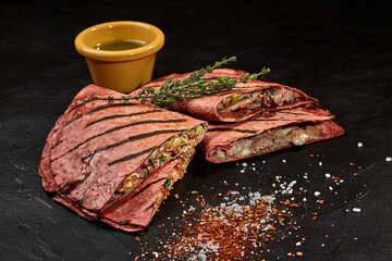 Mexican quesadillas in beetroot tortillas with spicy green sauce