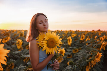girl in a field of sunflowers at sunset