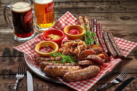 Fried sausages, potato wedges, stewed cabbage, sauces as beer snack