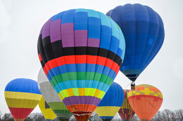 Colourful hot air balloons flying in the sky at the festival aeronautical. Adventure and funny holiday
