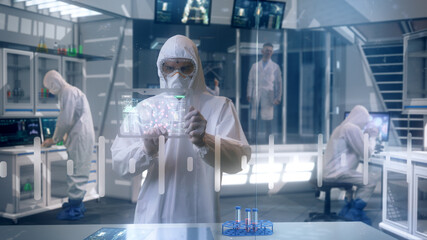 Inside Quarantine Secure High Level Laboratory Scientists in a Coverall Conducting a Research...