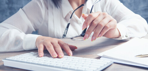 Fototapeta premium female hands typing on the keyboard