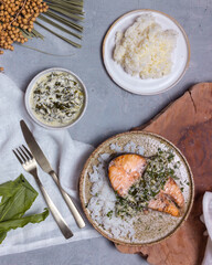 hot dish salmon steak with sorrel sauce on light background top view