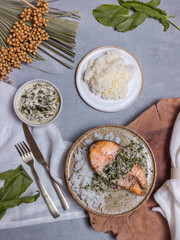 hot dish salmon steak with sorrel sauce on light background top view