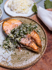 hot dish salmon steak with sorrel sauce on light background top view