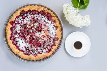 Aromatic homemade round pie with juicy fresh cherries. Top view of a culinary product