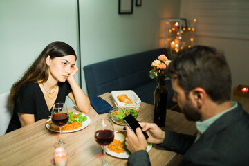 Angry wife waiting for her husband to pay attention