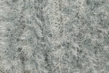 Texture of a shag rug made of synthetic materials, white threads.