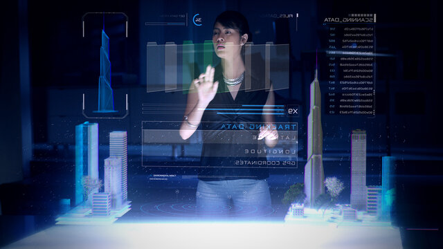 Female Architect works with Holographic Augmented Reality 3D City Model using gestures showing graphs. Technologically Advanced Office with Augmented Virtual Modeling Software on Futuristic Display. - Powered by Adobe