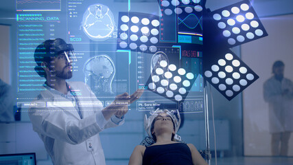 Doctor wearing holographic lenses analyzes patient with brain scan technology headset as he interacts with medical MRI results using augmented reality technology. Concept of: Medicine of the Future.