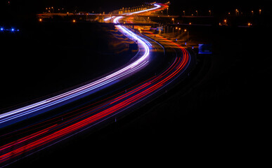 Fototapeta na wymiar night highway, long exposure of cars lights on the night road