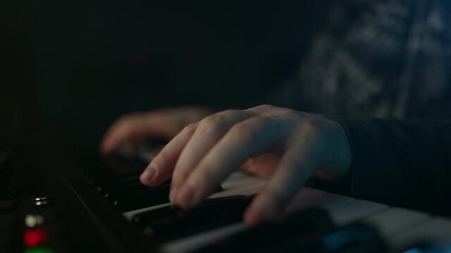 Man composing new song in recording studio.
