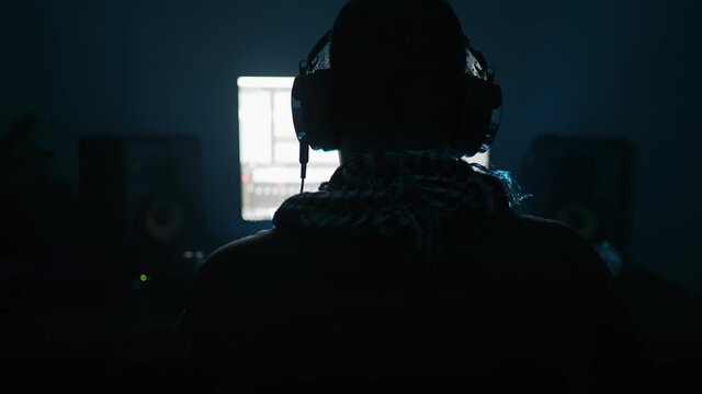 DJ making his new track in recording studio.