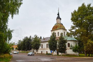 Fototapeta na wymiar Kirov, Russia - August 31, 2020: An old Christian Orthodox church with domes and crosses on a summer day in Russia and parking for cars