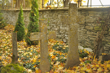 Stone crosses in the old cemetery in autumn
