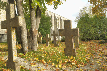 Stone crosses in the old cemetery in autumn