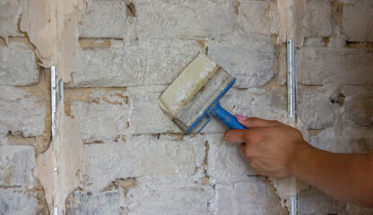 woman paints the wall with a brush. construction.