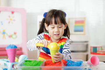 young girl playing color sorting and fine motor skill for homeschooling