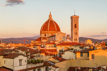Florence's beautiful Gothic cathedral and bell tower standing out over the surrounding city buildings at sunset