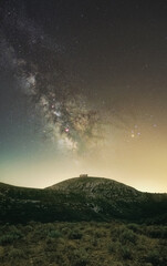 Milky Way over Montgrí Castle in Costa Brava during a vacation and warm summer night. 
