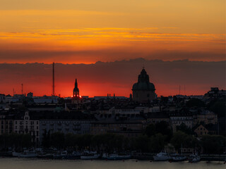 Fototapeta premium Cityscape sunset in vibrant red and orange colors