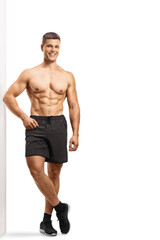 Obraz premium Full length portrait of a shirtless sportsman wearing shorts and smiling