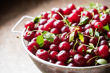 Cherries in a steel sieve. top view, texture