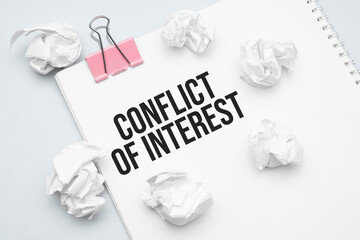 Conflict of interest. Blank sheet of paper, red paper clip, word Ideas and crumpled paper wads